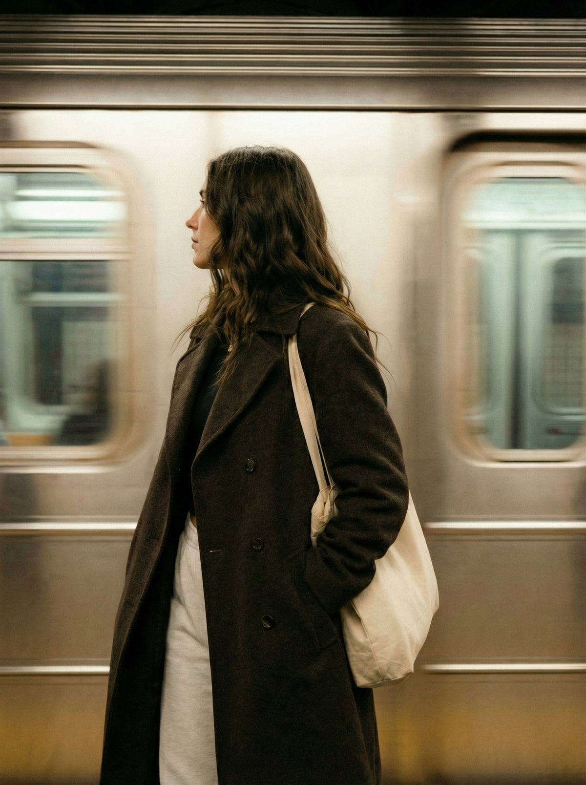 A woman still on the platform as the train rushes past